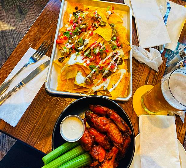 istock Nachos, wings and beer. 2240438785