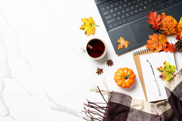 istock Laptop, notebook, coffee cup and yellow leaves. 2240441034