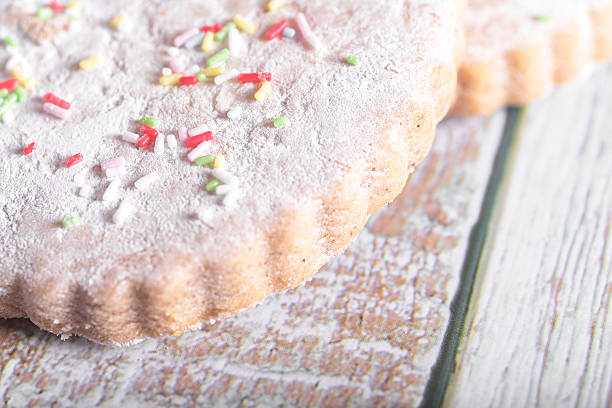 A delightful assortment of cookies and milk with colorful sprinkles on a rustic wooden background, perfect for National Cookie Day celebrations
