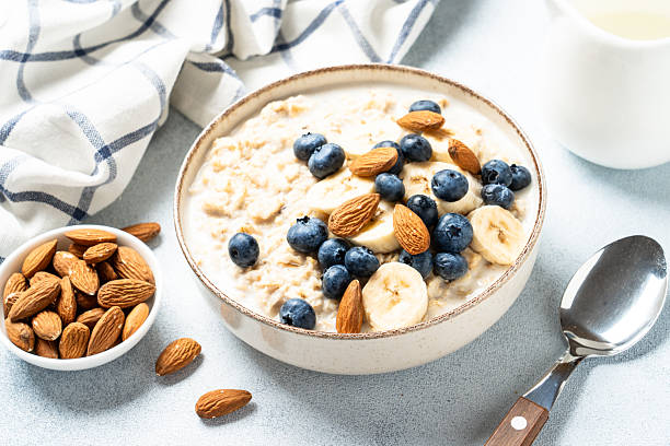 istock Oatmeal porridge with bananas, nuts and blueberries. 2240443068