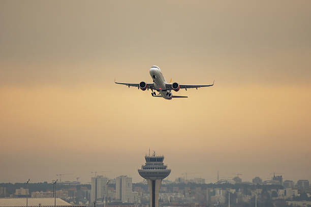 istock An airplane with its engines at maximum power leaving the runway on a sunset with reddish skies 2240443781