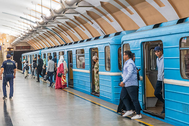 Tashkent, Uzbekistan - August 5, 2025. Interior view of the Chorsu subway station in Tashkent. People are waiting for the next train or waliking down the platform.