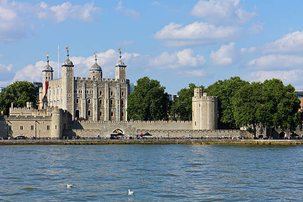 London, England - July 13, 2025: Daytime view of the Tower of London beside the River Thames in London, England. The historic fortress and former royal residence is a UNESCO World Heritage Site.