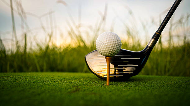 istock Golf ball on green grass in the evening golf course with sunshine background. 2240448076