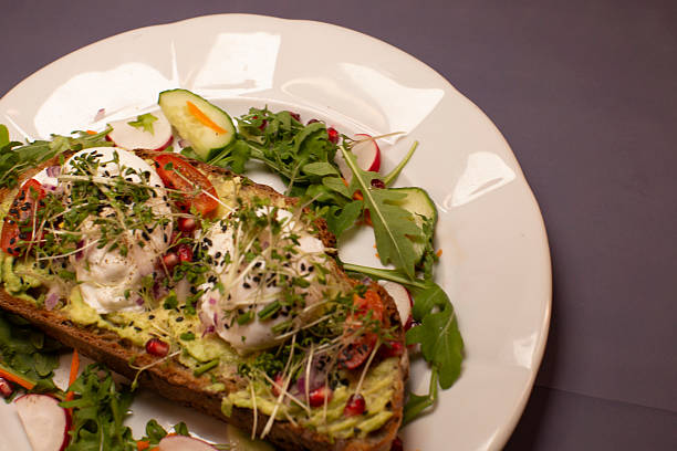 Avocado Toast with Poached Eggs and Fresh Vegetables for a delightful meal