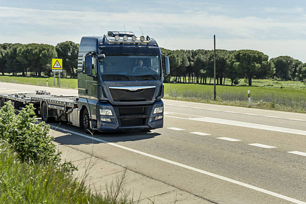istock A tractor truck driving with an empty trailer on a county road 2240452218