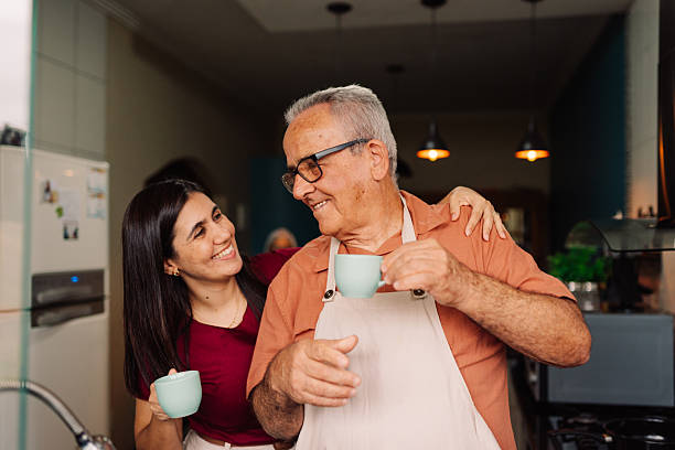 istock Father and daughter having coffee together in the kitchen 2240455972