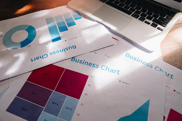 istock Data Visualization concept. Business Charts and Graphs on Wooden Table with Laptop, Analysis and Data Presentation Concept in Bright Setting 2240460120