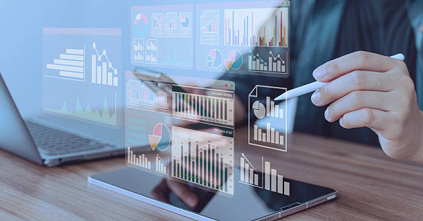 istock Person using stylus and laptop with multiple floating financial dashboards, symbolizing data analytics, investment, and fintech tools 2240462373