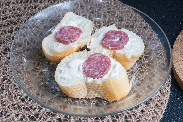 Sandwiches with salami and cheese on the table .