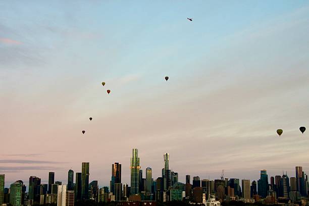 istock Hot air balloons with Melbourne skyline at dusk 2240474803