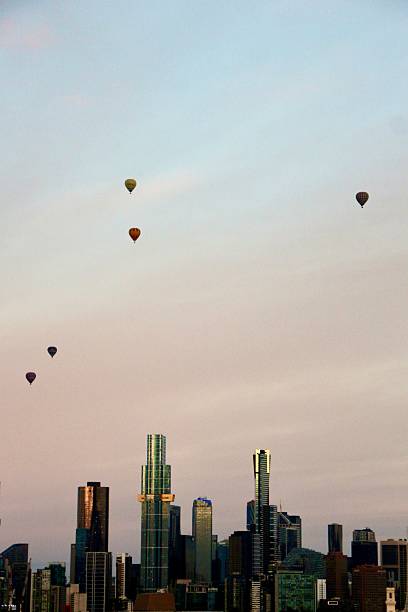 istock Hot air balloons with Melbourne skyline at dusk 2240474805