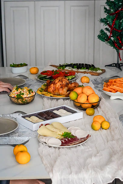 istock Festive holiday table with roasted chicken, salads, mandarins and tableware 2240477968