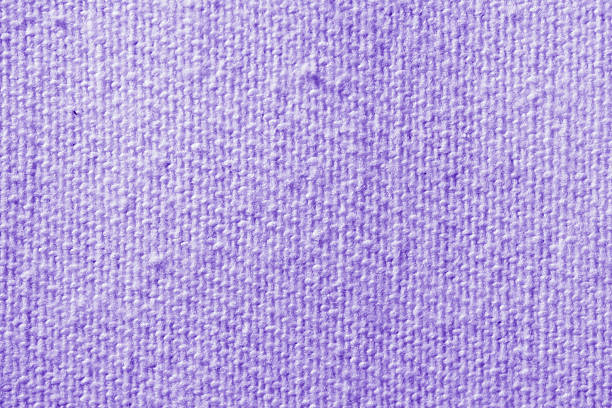 Macro view of textured purple wool fabric with visible weave and soft fuzzy surface. Great for textile design, fashion, and cozy background concepts.