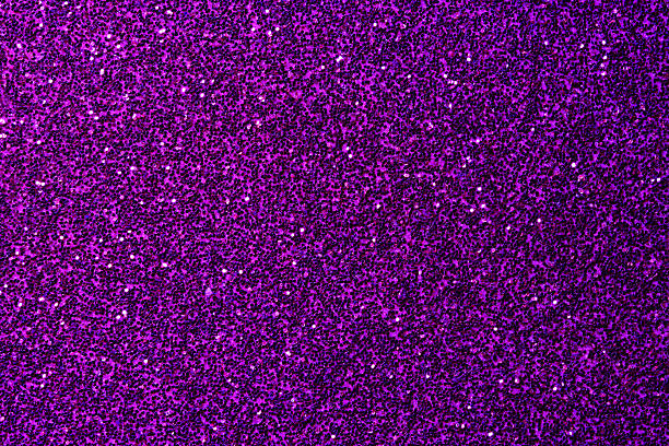 Close-up of shimmering purple glitter creating a sparkling, textured background. Perfect for party, festive, and glamorous design themes.