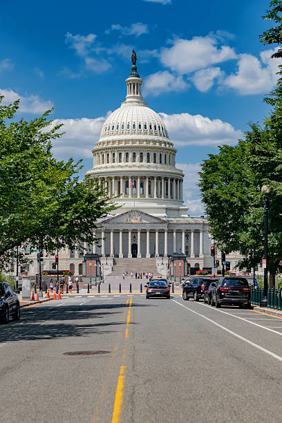 istock Majestic Capitol dome in daylight. Surrounded by vibrant green trees. 2240480074