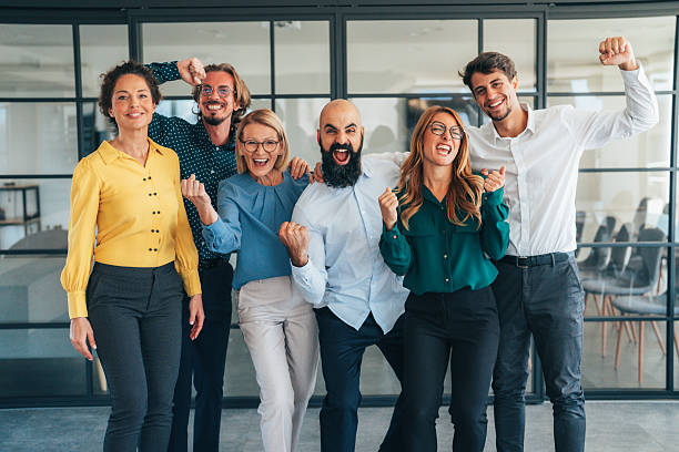 istock Business team embracing after achieving goals 2240483044