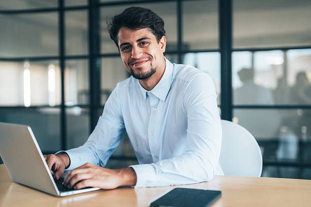 istock Confident young businessman managing work online 2240483050