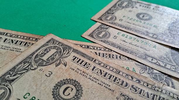 istock Dollar bills on a green background 2240483298
