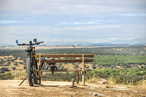 nice, active senior woman with her electric mountain bike on a trail tour in the dessert of Tabernas near Almeria, Andlusia, Spain