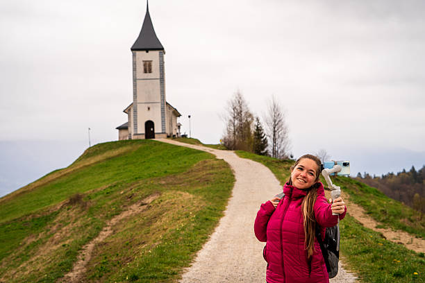 Tourist documenting hidden places in Slovenia with her camera.