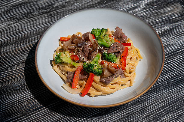 istock Top view of pasta with beef and broccoli. 2240491172