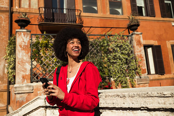 istock Smiling woman with smartphone in Rome 2240493910