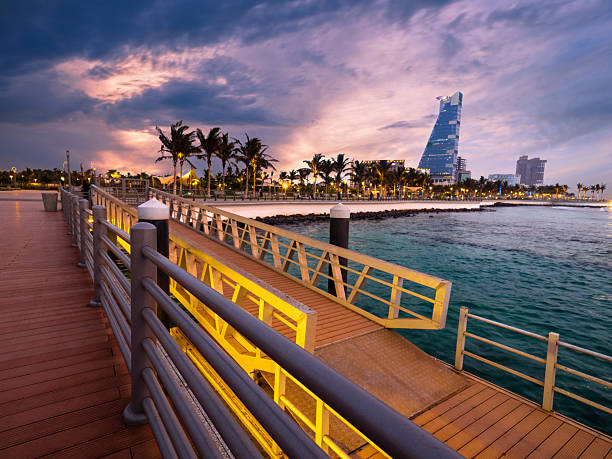 Stunning sunset view of Jeddah waterfront, Saudi Arabia, featuring the city’s modern skyline glowing with warm evening light and reflecting beautifully on the Red Sea waters.