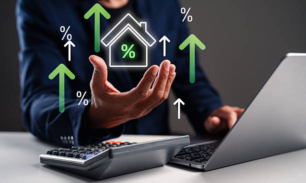 istock A person analyzing real estate data on a laptop, with growth indicators and percentages represented graphically. 2240497513