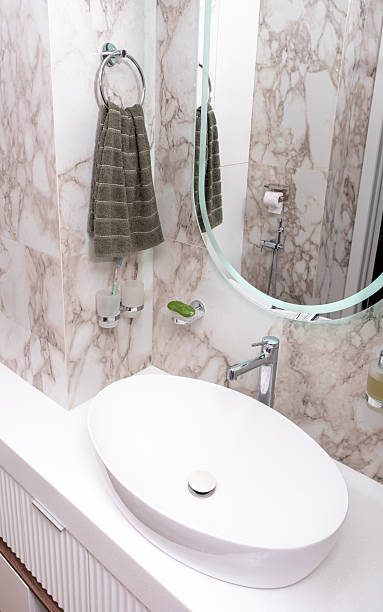 istock bathroom features sleek oval sink, marble walls, and soft lighting creating serene atmosphere for personal care activities 2240501203