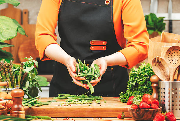 istock Chef carefully selects vibrant vegetables and herbs on cutting board in cozy kitchen, focusing on healthy meal preparation 2240501230