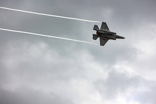 a large vapor cloud called a Prandti-Glauert singularity surrounding the F-22 fighter jet at high speeds