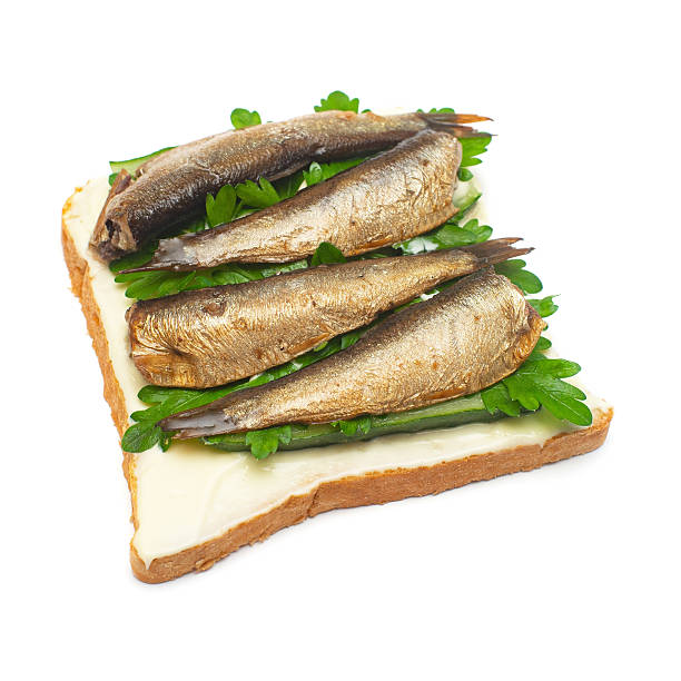 istock Sandwich with bread, sprats and parsley isolated on white background. Flat lay, top view 2240507223