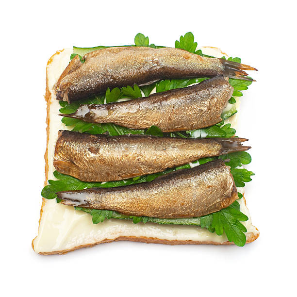 istock Sandwich with bread, sprats and parsley isolated on white background. Flat lay, top view 2240507224