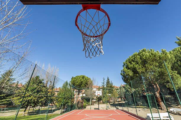 istock A basketball basket on a court with artificial floor surrounded 2240510075