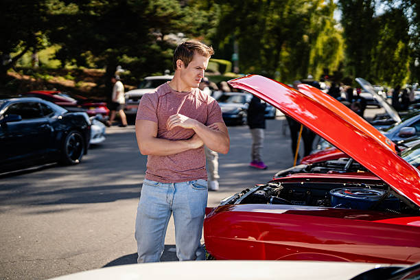 istock Man Standing by Muscle Car at Meetup 2240513289