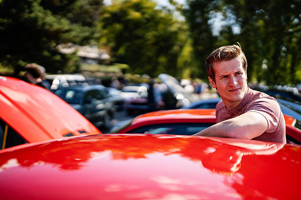 istock Man Standing by Muscle Car at Meetup 2240513295