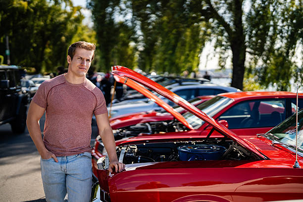 Man Standing by Muscle Car at Meetup