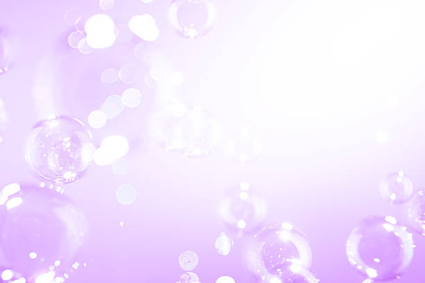 Beautiful Shiny Purple Soap Bubbles Floating in The Air. Purple and White Gradient Textured. Celebration Festive Backdrop. Freshness Soap Suds Bubbles Water.