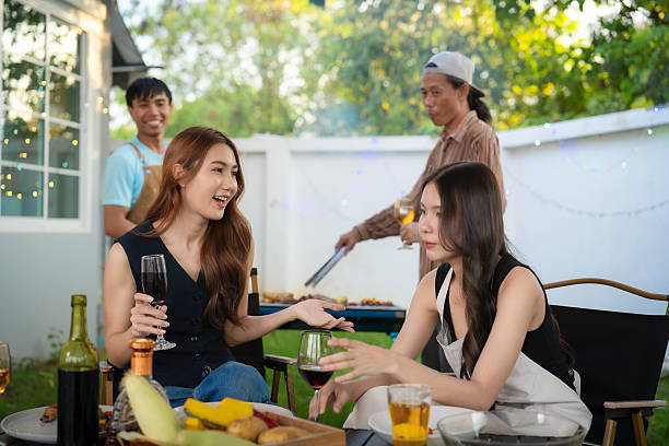 istock A group of multiracial friends are having a backyard dinner party, clinking beers or sharing drinks during happy hour. Young people are having fun together and clinking beers while standing in the garden. 2240515748