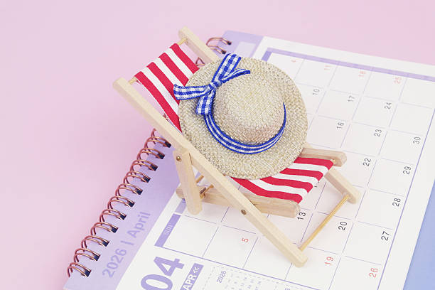 istock Red beach chair with hat on calendar on pink background. 2240521569