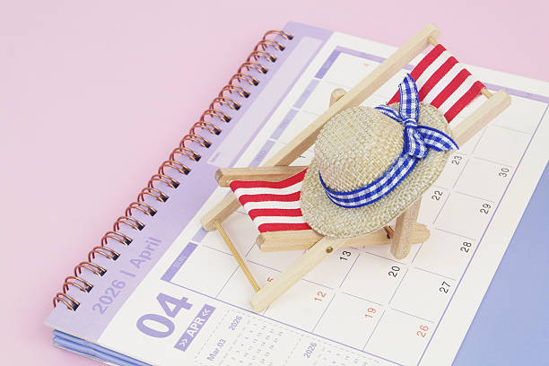 istock Red beach chair with hat on calendar on pink background. 2240521614
