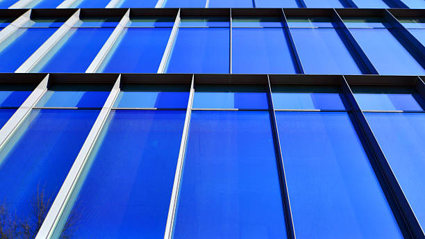 istock Exterior of modern building with many windows against blue sky, low angle view. 2240525748