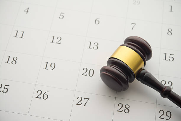 istock Judge wood gavel hammer on white blank calendar background copy space. 2240525867