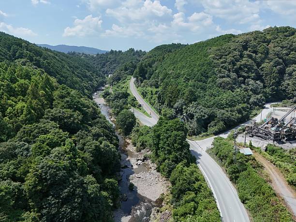 A mountain road with a river running alongside it