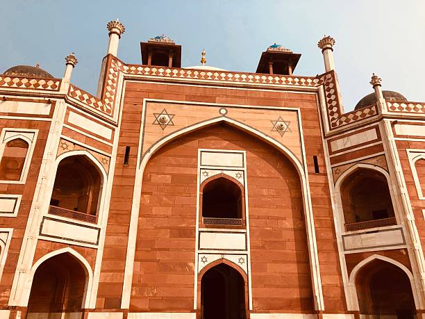 The Humayun's Tomb in Delhi stands as an architectural masterpiece and a pivotal example of Mughal design. Built in 1570, this tomb laid the groundwork for Mughal structures that followed, most notably the Taj Mahal. The complex features an amalgamation of Persian and Indian architectural elements, including the charbagh—a four-quadrant garden layout. This image captures the tomb's well-preserved facades, intricate stonework, and lush gardens, providing a comprehensive view of this UNESCO World Heritage site. The photograph aims to highlight both the historical and aesthetic elements that make this monument a must-visit landmark in India.