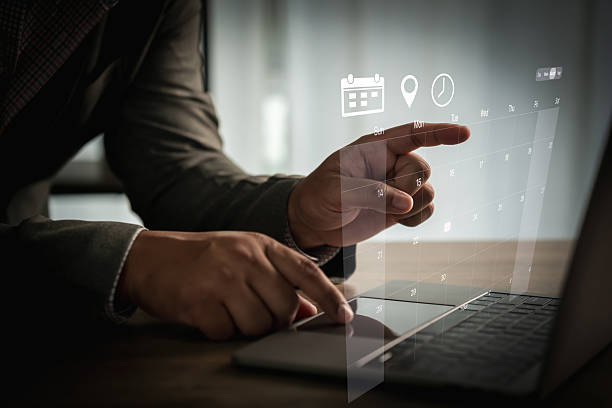 istock Calendar schedule Business professional using laptop with holographic calendar interface to plan schedules, set appointments, and manage deadlines in a modern office 2240531275