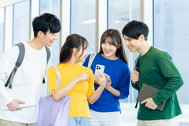 istock Male and female university students using smartphones 2240533548