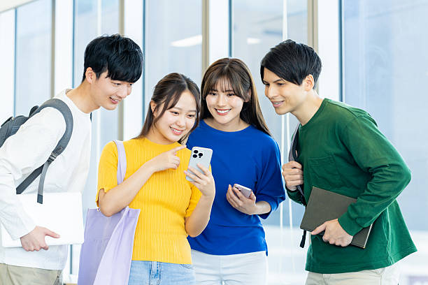 istock Male and female university students using smartphones 2240533553