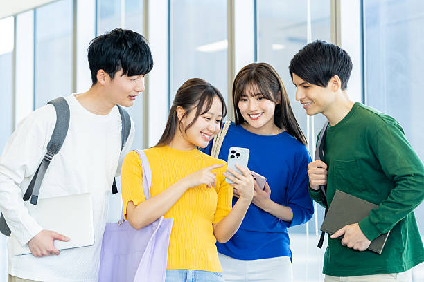istock Male and female university students using smartphones 2240533561